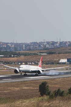 Turkish Airlines aircraft touches down at İstanbul airport on a clear day.