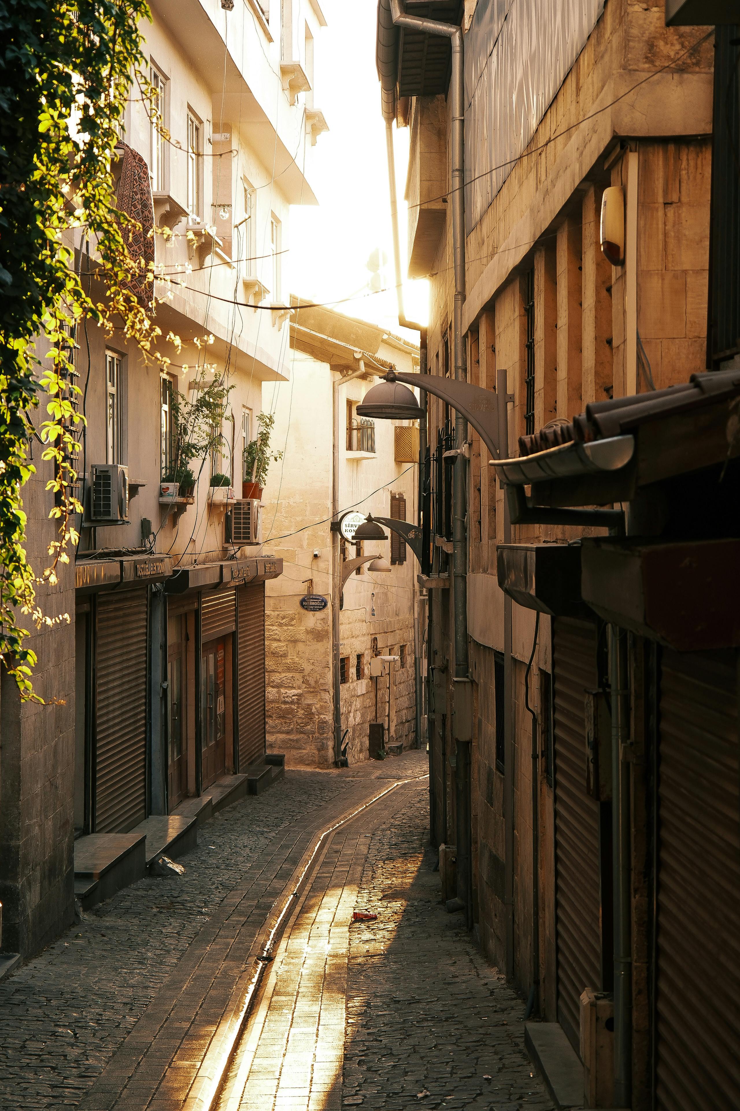 A cozy, sunlit alleyway in a historic city at golden hour, reflecting warmth and tranquility.