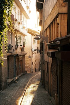 A cozy, sunlit alleyway in a historic city at golden hour, reflecting warmth and tranquility.