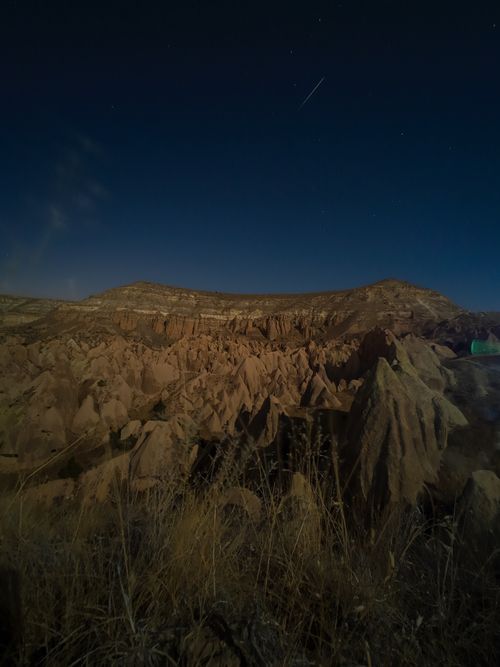 Free A captivating night view of a rocky landscape under a starry sky, showcasing natural beauty. Stock Photo