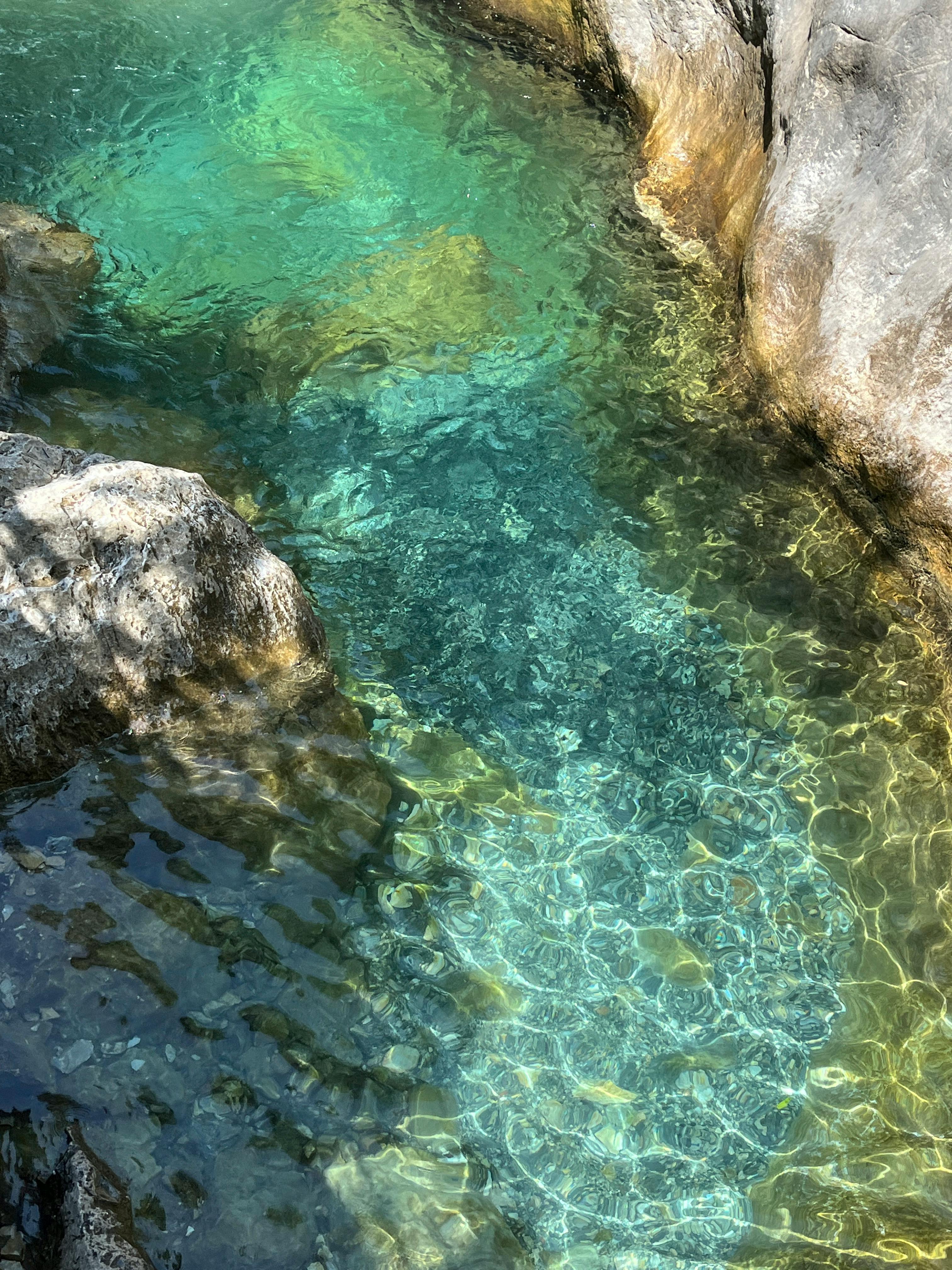 Stunning turquoise waters flowing through Sapadere Canyon illuminated by sunlight.