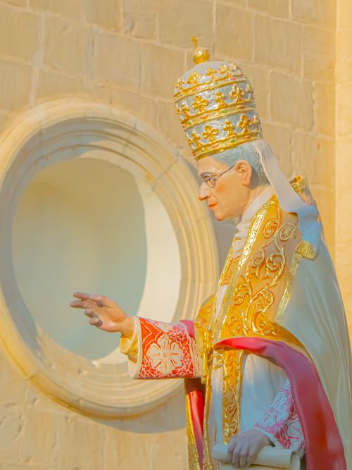 Free An ornate statue depicting a pope with intricate gold and red vestments in a Maltese church setting. Stock Photo