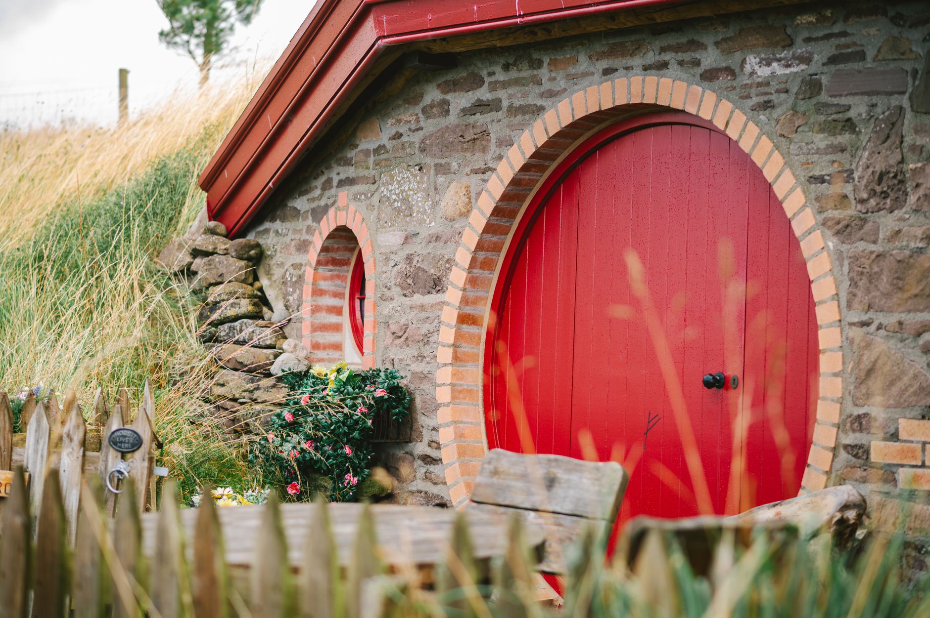 Picturesque Hobbit-style house with red round door in Dunblane, Scotland. Ideal for fantasy fans.