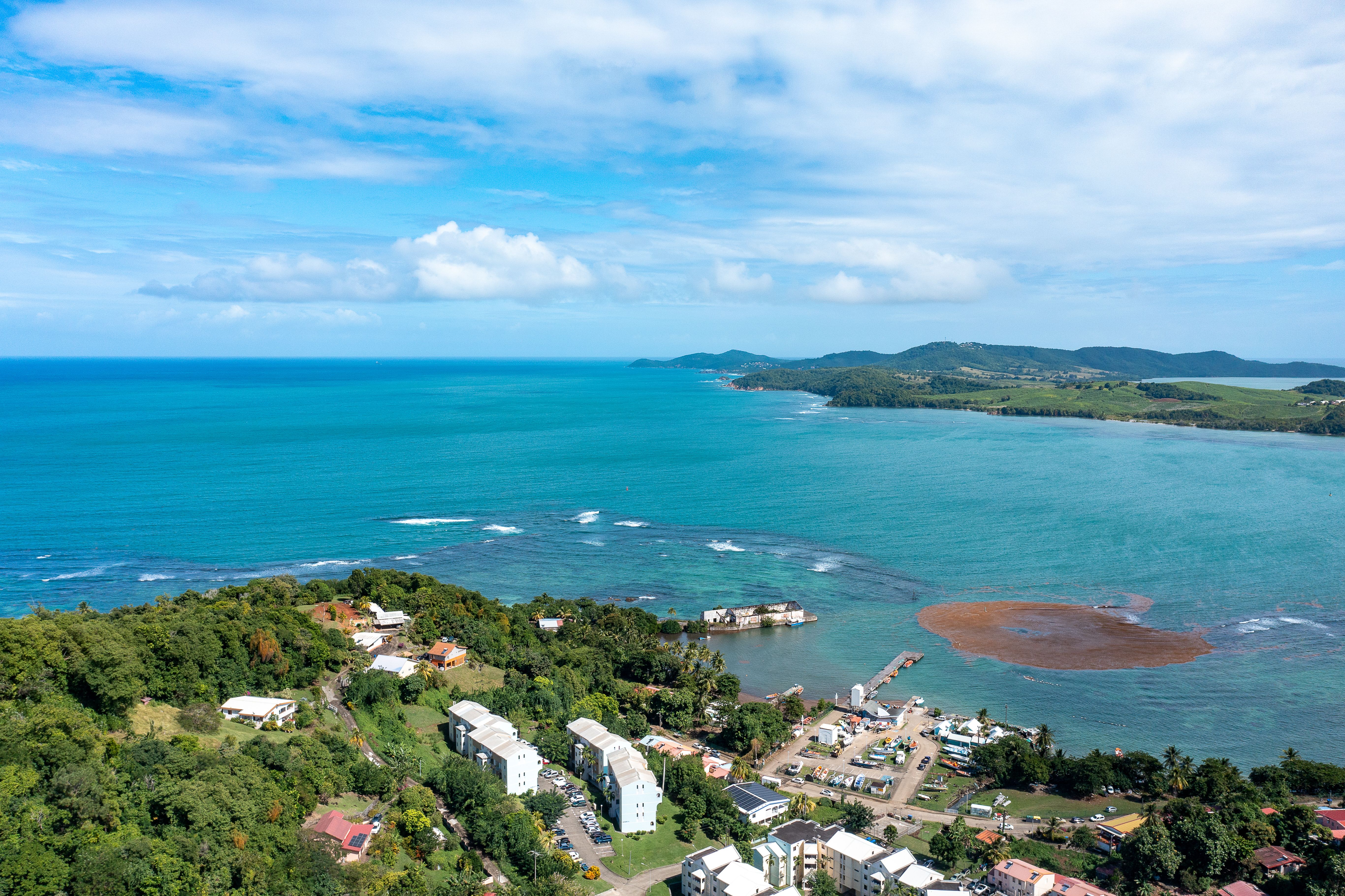 aerial-view-of-coastal-town-and-blue-ocean-free-stock-photo