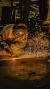 Industrial Welder at Work Amidst Sparks