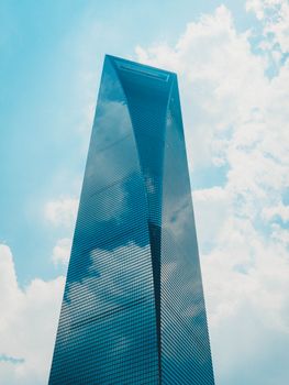 The Shanghai Tower rises majestically against a bright blue sky, symbolizing modern architecture.