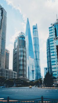 Striking view of Shanghai's iconic skyscrapers under a bright blue sky.