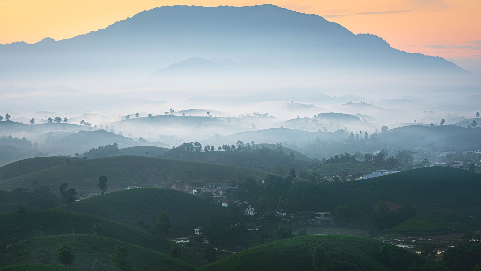 A peaceful misty mountain view with rolling hills and sunrise hues.. peaceful, misty, mountain