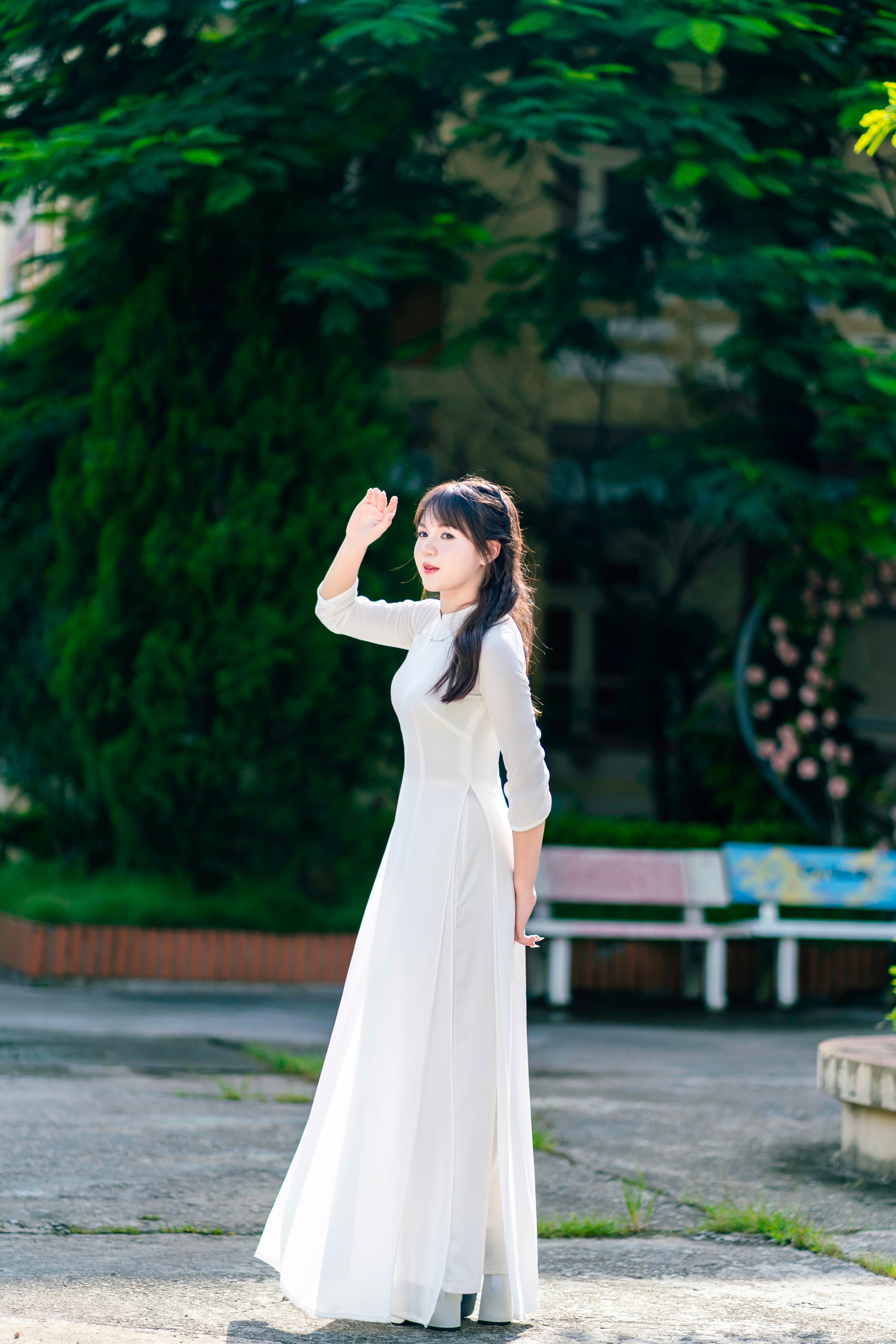 Elegant Woman in Long White Dress Outdoors  Free Stock Photo