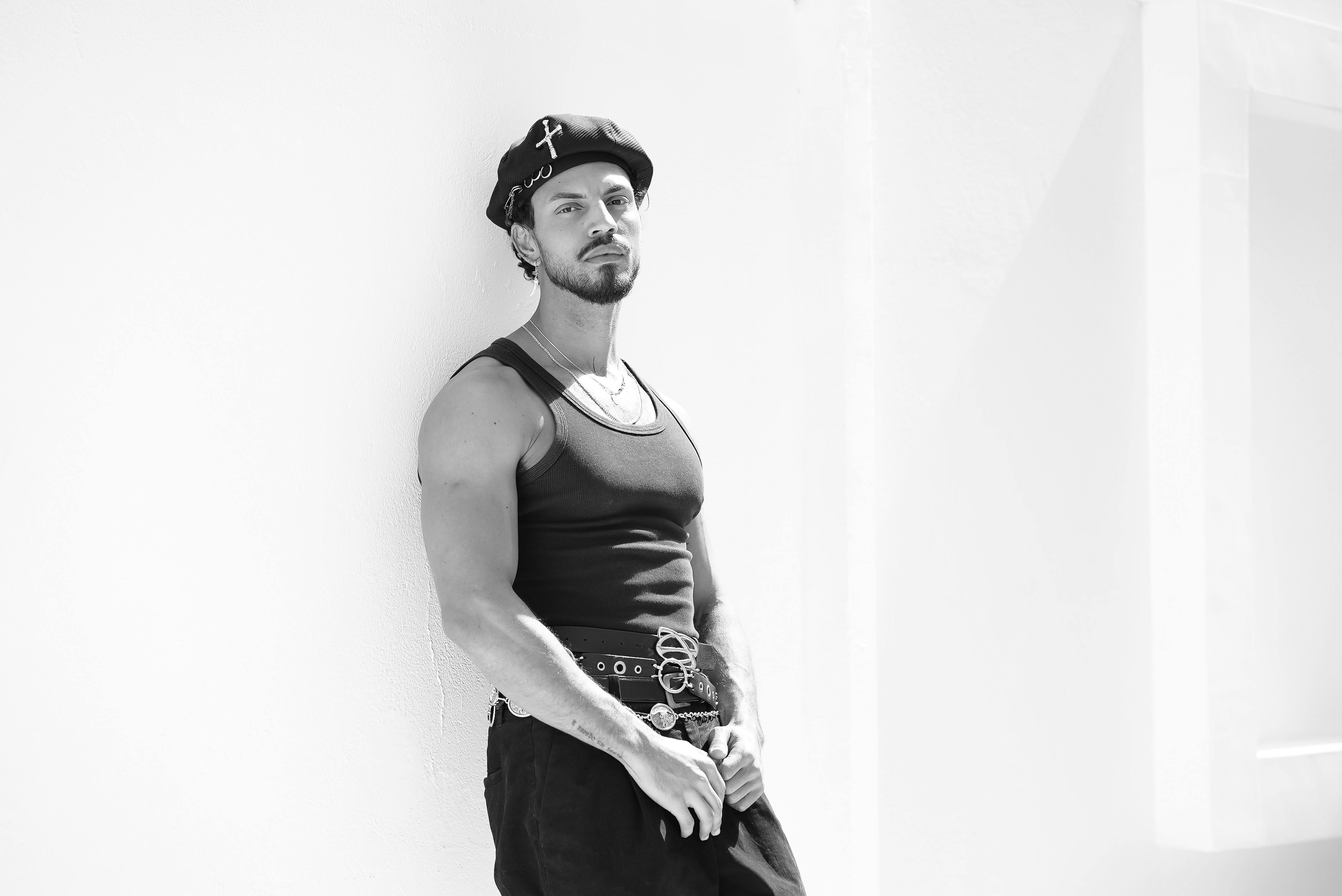 Free Black and white photo of a stylish man leaning against a wall in São Paulo, Brazil. Stock Photo