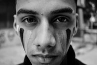 Young man with warrior face painting