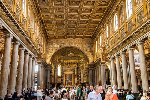 Free The opulent interior of Santa Maria Maggiore, capturing ornate details and visitors. Stock Photo