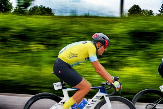 Male cyclist in a yellow jersey racing at high speed outdoors, captured in Samsun, Türkiye.