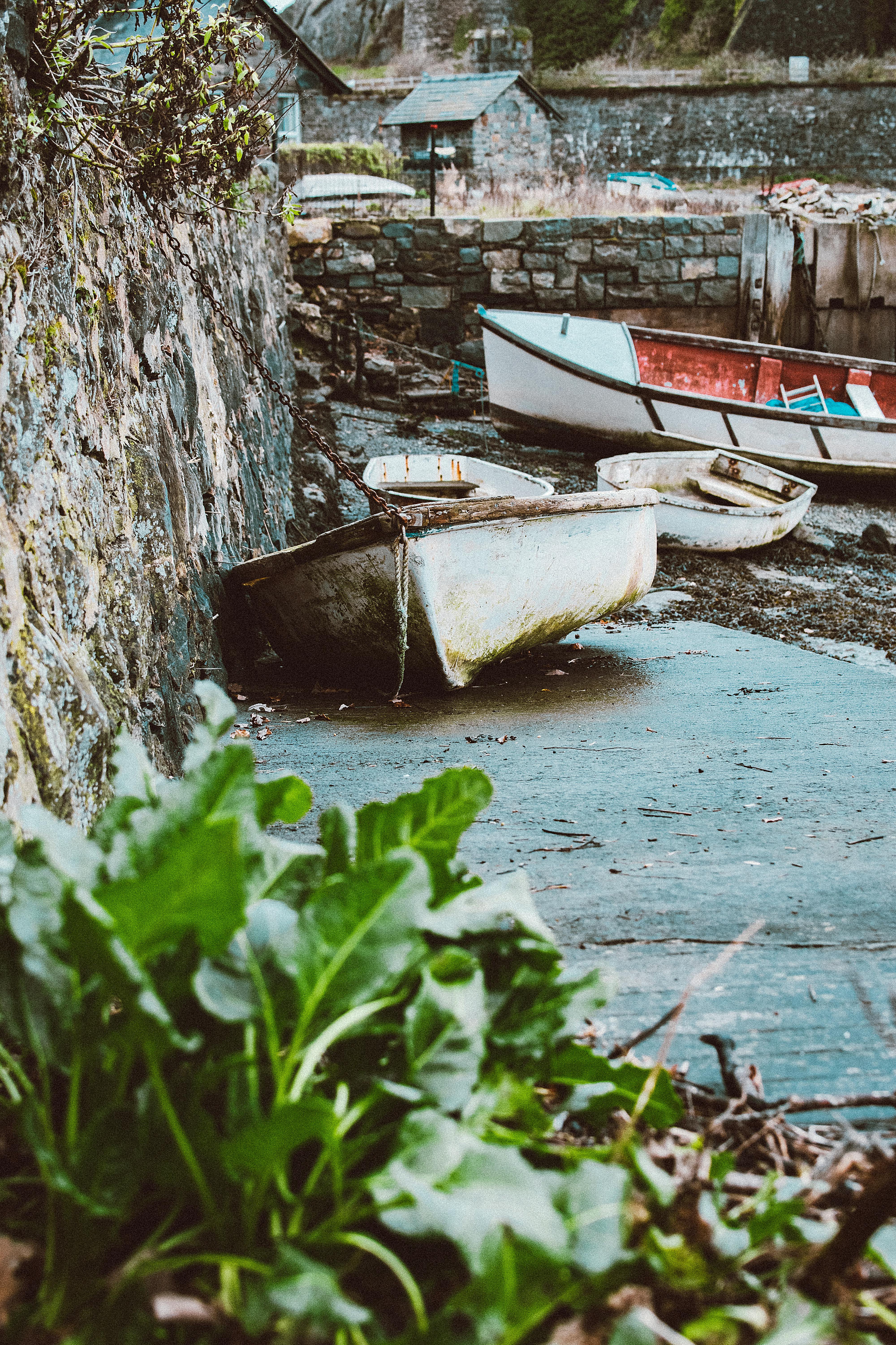 Old rusty boats in a rustic and abandoned docking area, perfect for travel and transportation themes.