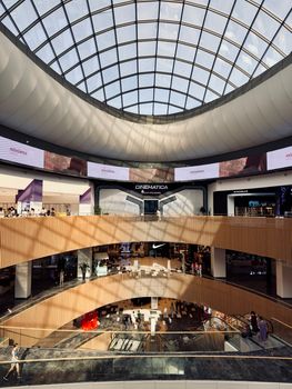Spacious multi-level shopping mall with a stunning glass dome roof.