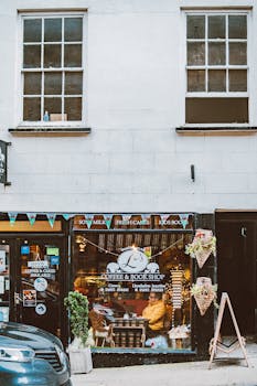 Capture of a quaint coffee and book shop facade on a bustling city street, inviting ambiance.