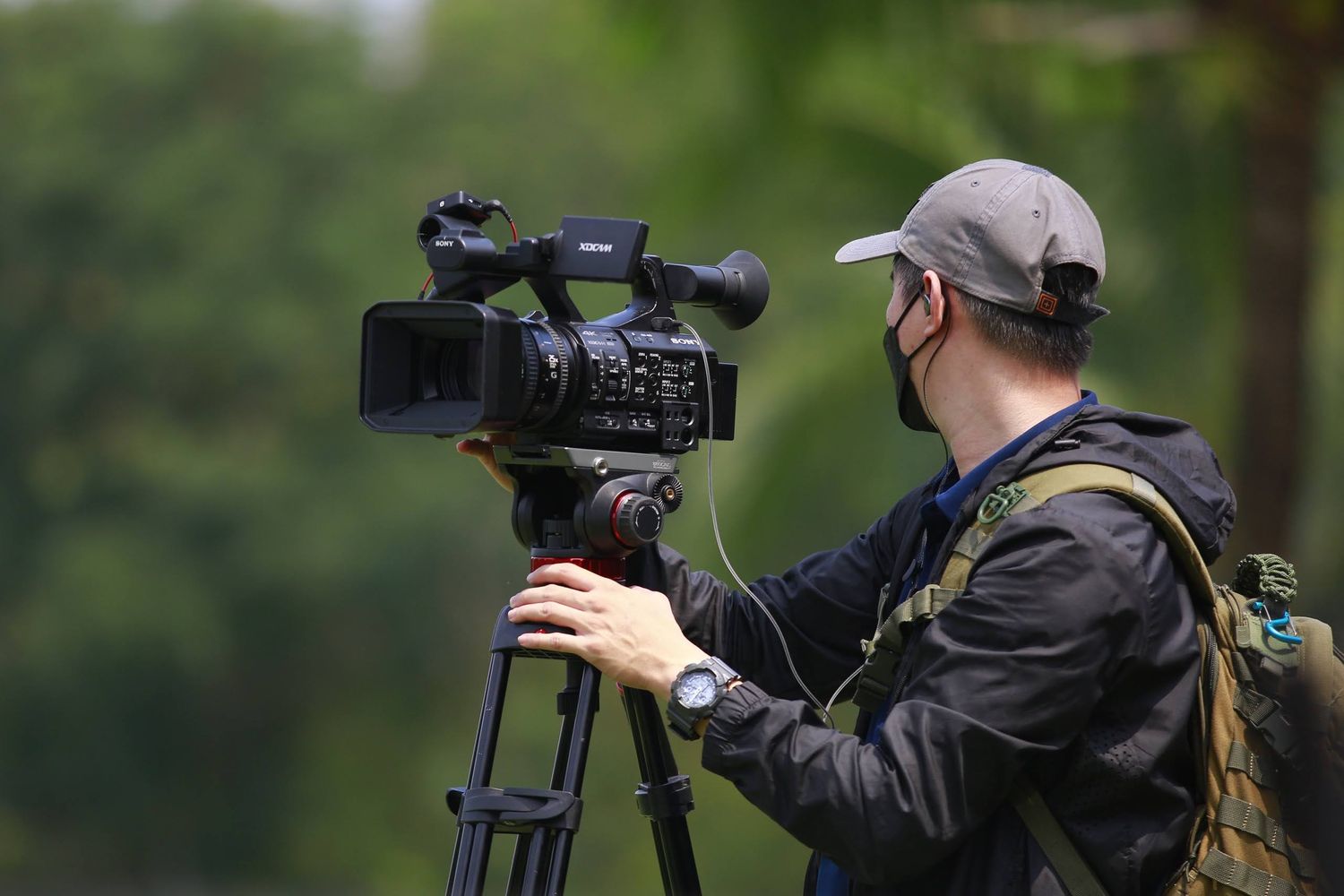 Directeur photo utilisant une caméra professionnelle sur un tournage extérieur