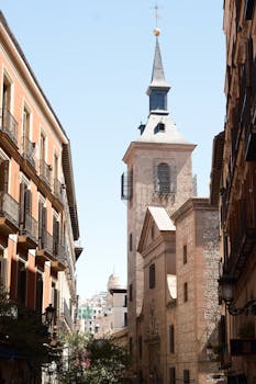 A stunning view of a historic church tower in Madrid, showcasing classic Spanish architecture.