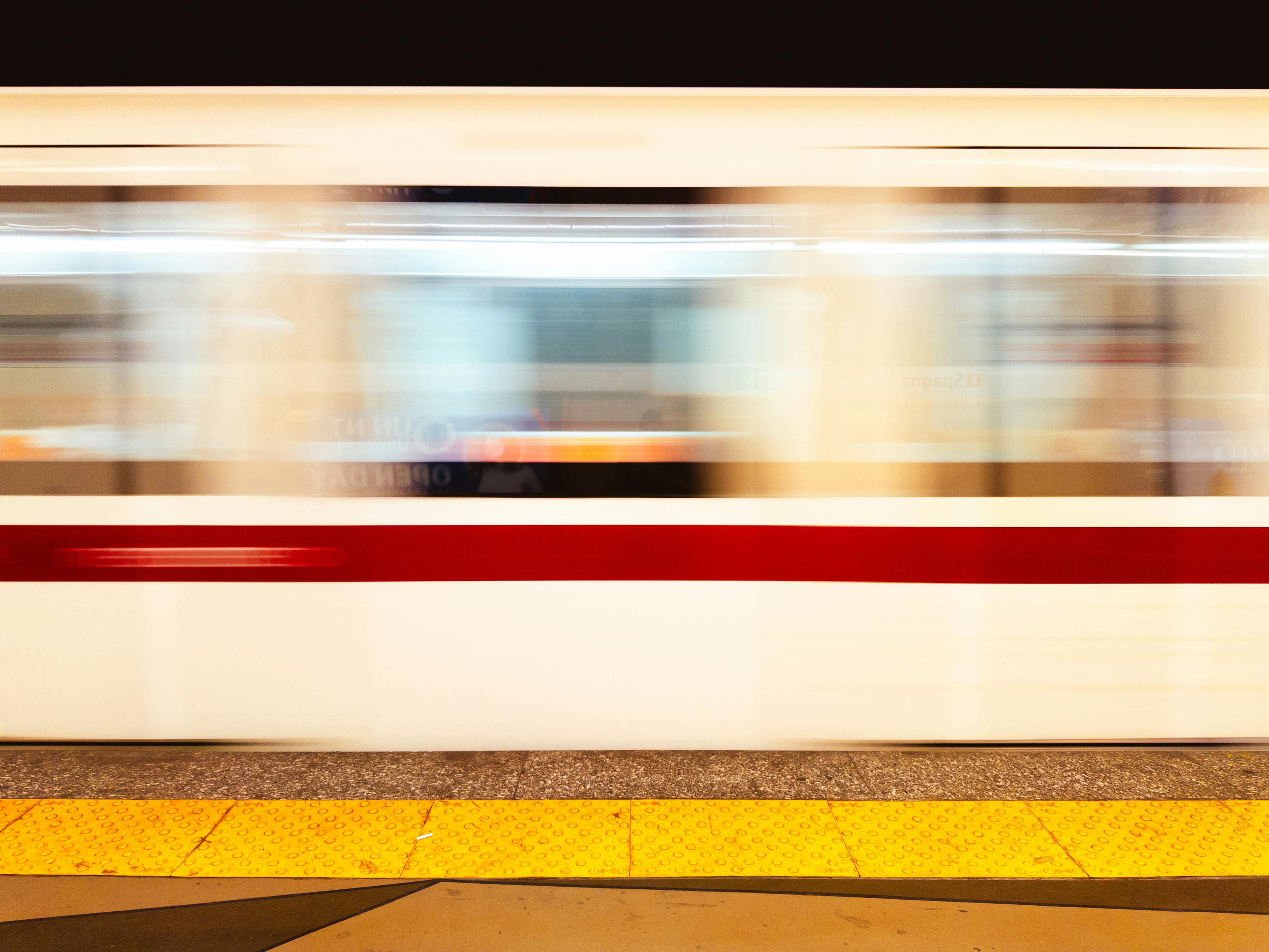 A fast-moving train captured in motion blur at a station in Lazio, Italy.