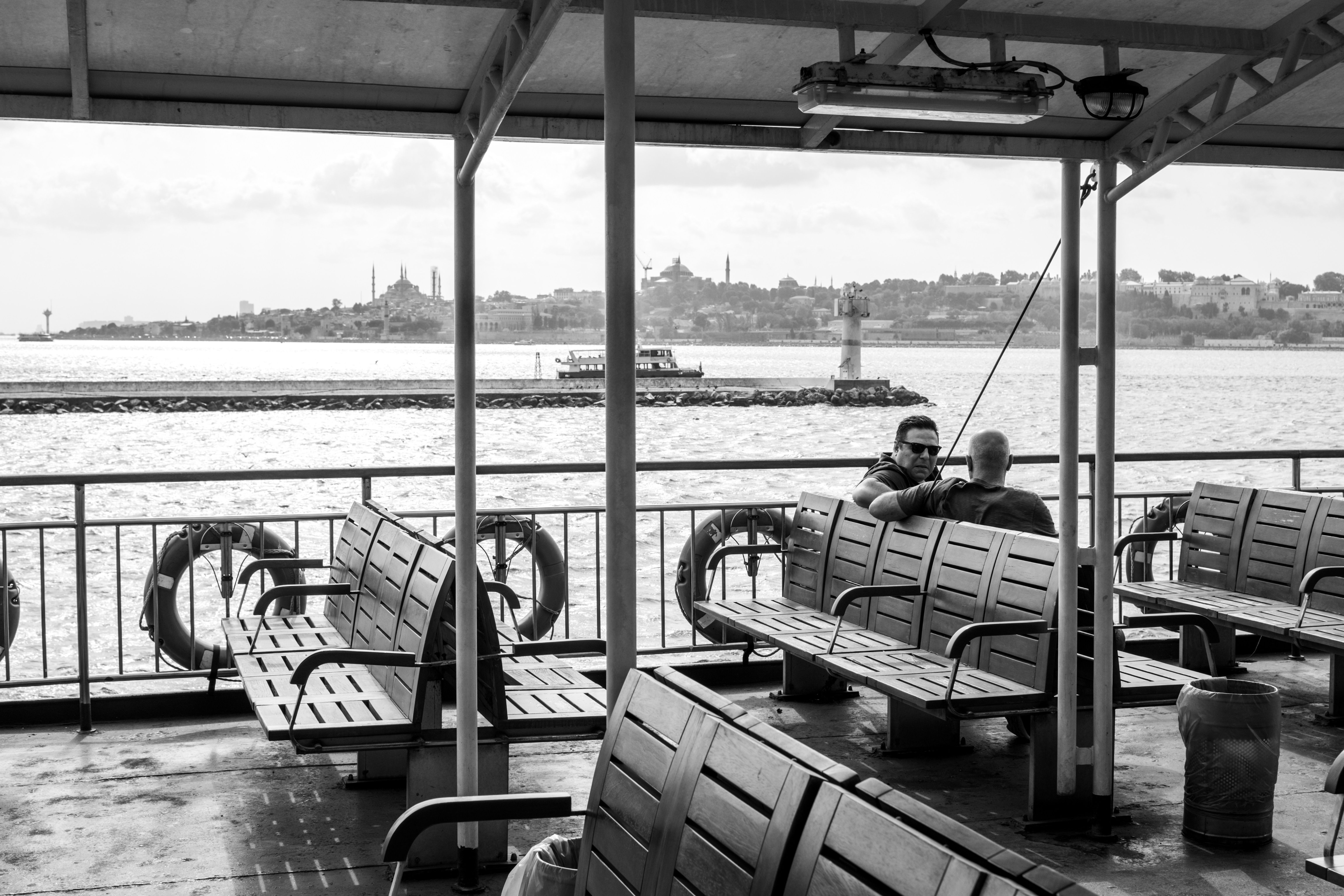 Monochrome image of a ferry in İstanbul with cityscape view.