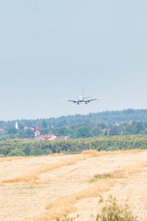 Free Airliner approaching runway with scenic landscape and town in Poprad, Slovakia. Stock Photo