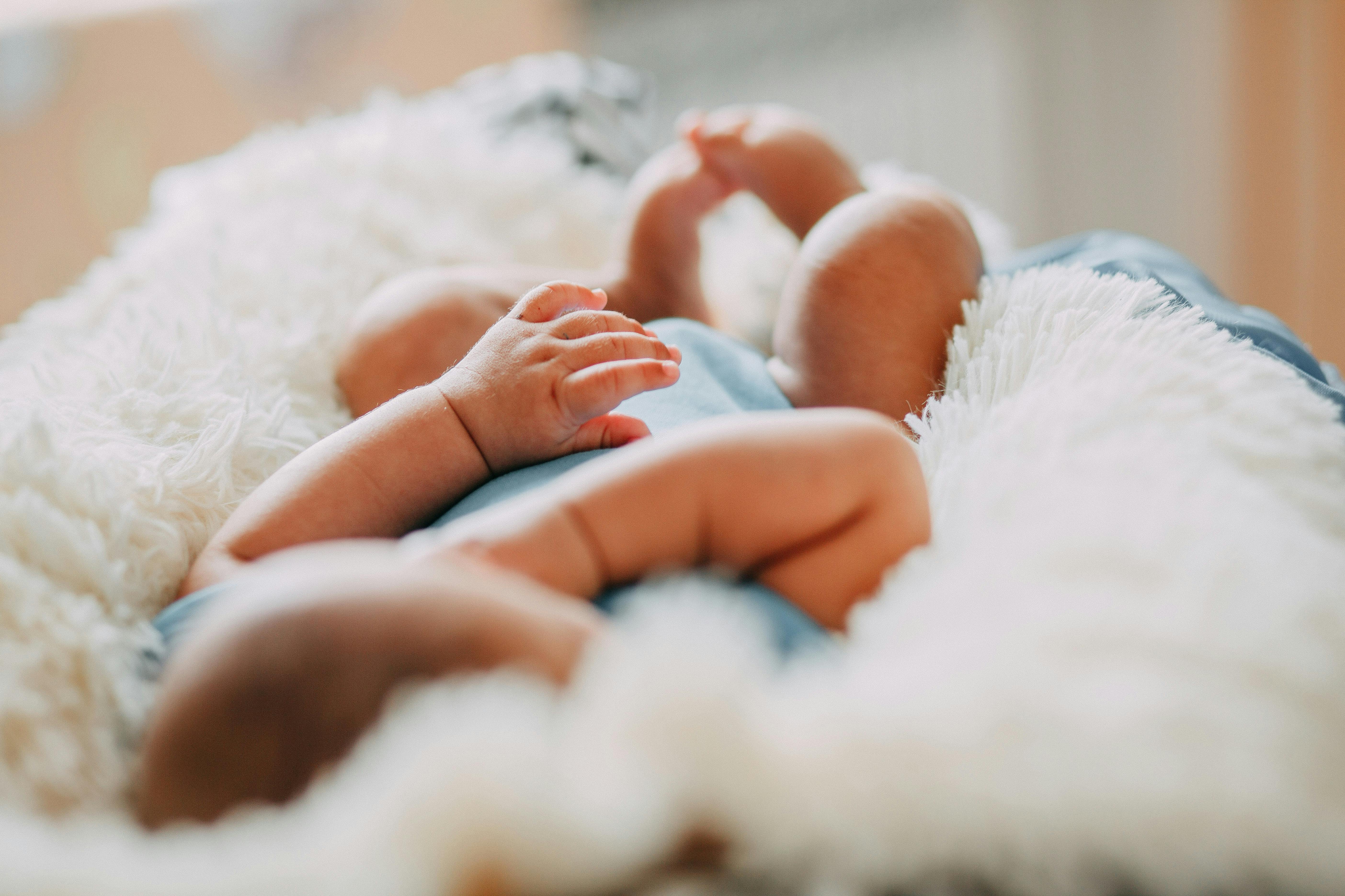 photo of baby laying on fleece blanket