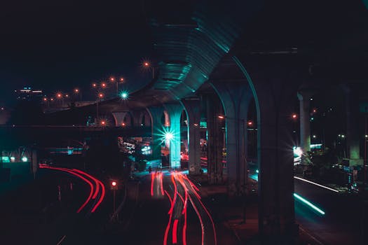 Dynamic urban night scene featuring vibrant light trails under elevated roads.