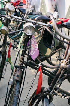 Artistic shot of vintage bicycles parked together with colorful flags in daylight.
