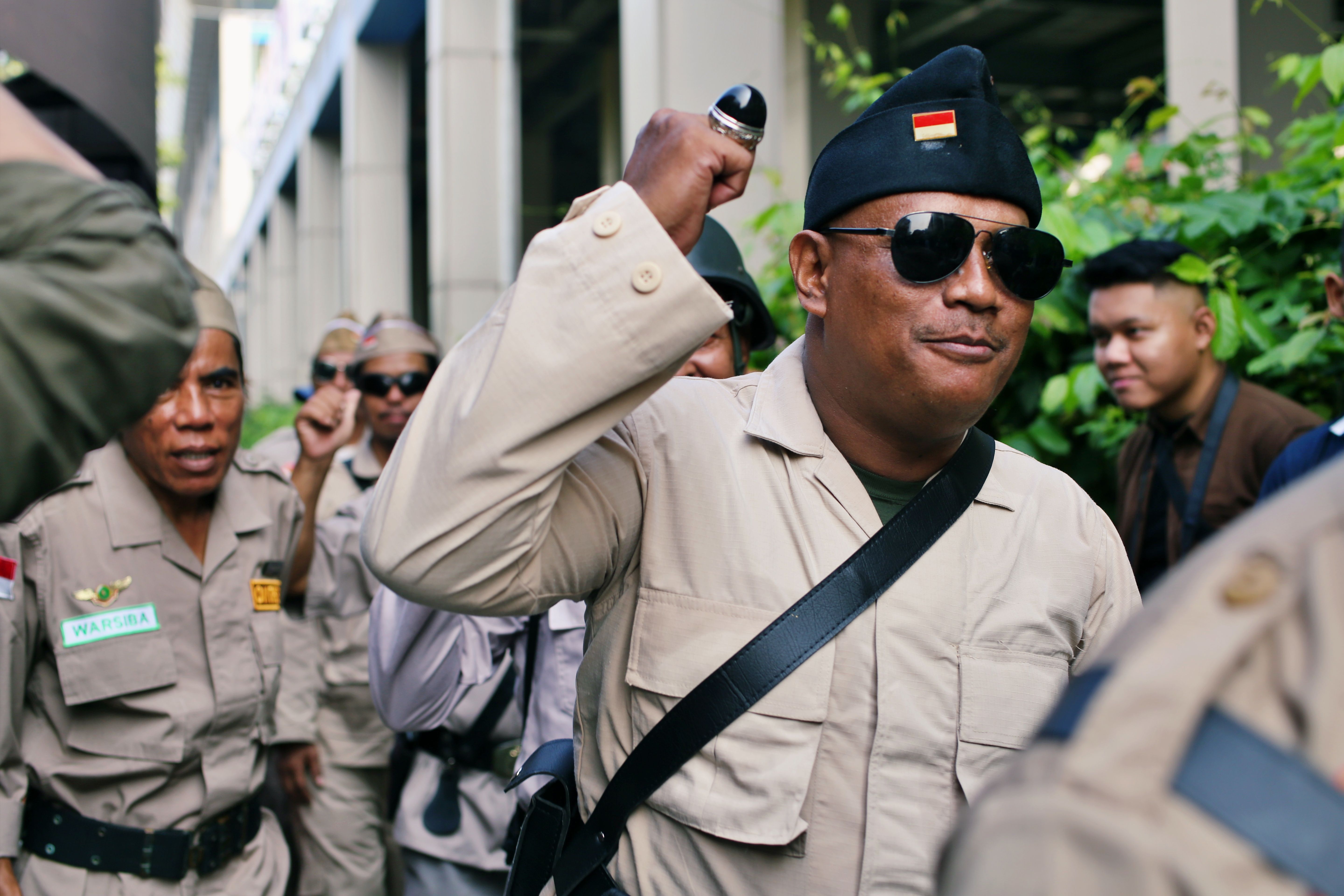 Uniformed Men Gathering Outdoors in Urban Setting