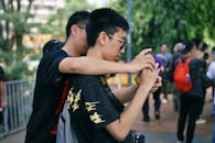 Young Adults Capturing Moments with Smartphone