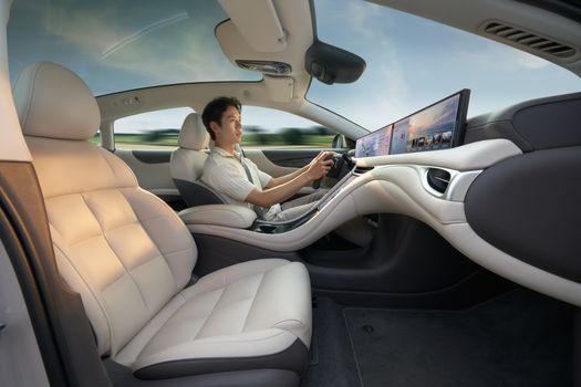 A modern electric car interior showcasing advanced technology with a driver enjoying a smooth ride.