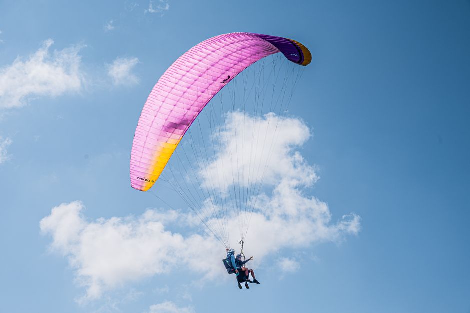 pexels photo 33412090 Experience the thrill of tandem paragliding with colorful parachute soaring high in the clear blue sky.