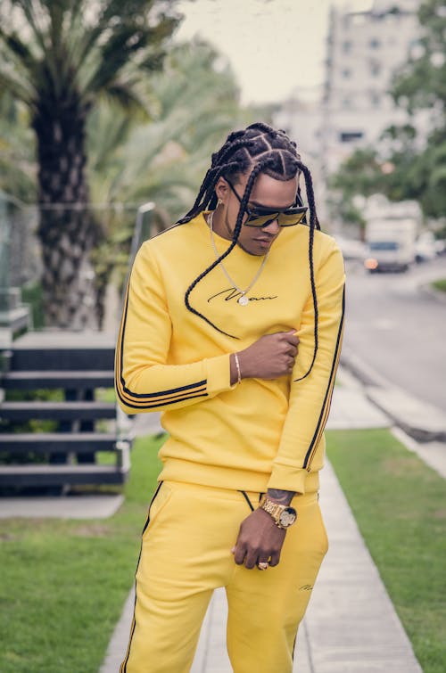 Man with Braided Hair in Yellow Outfit