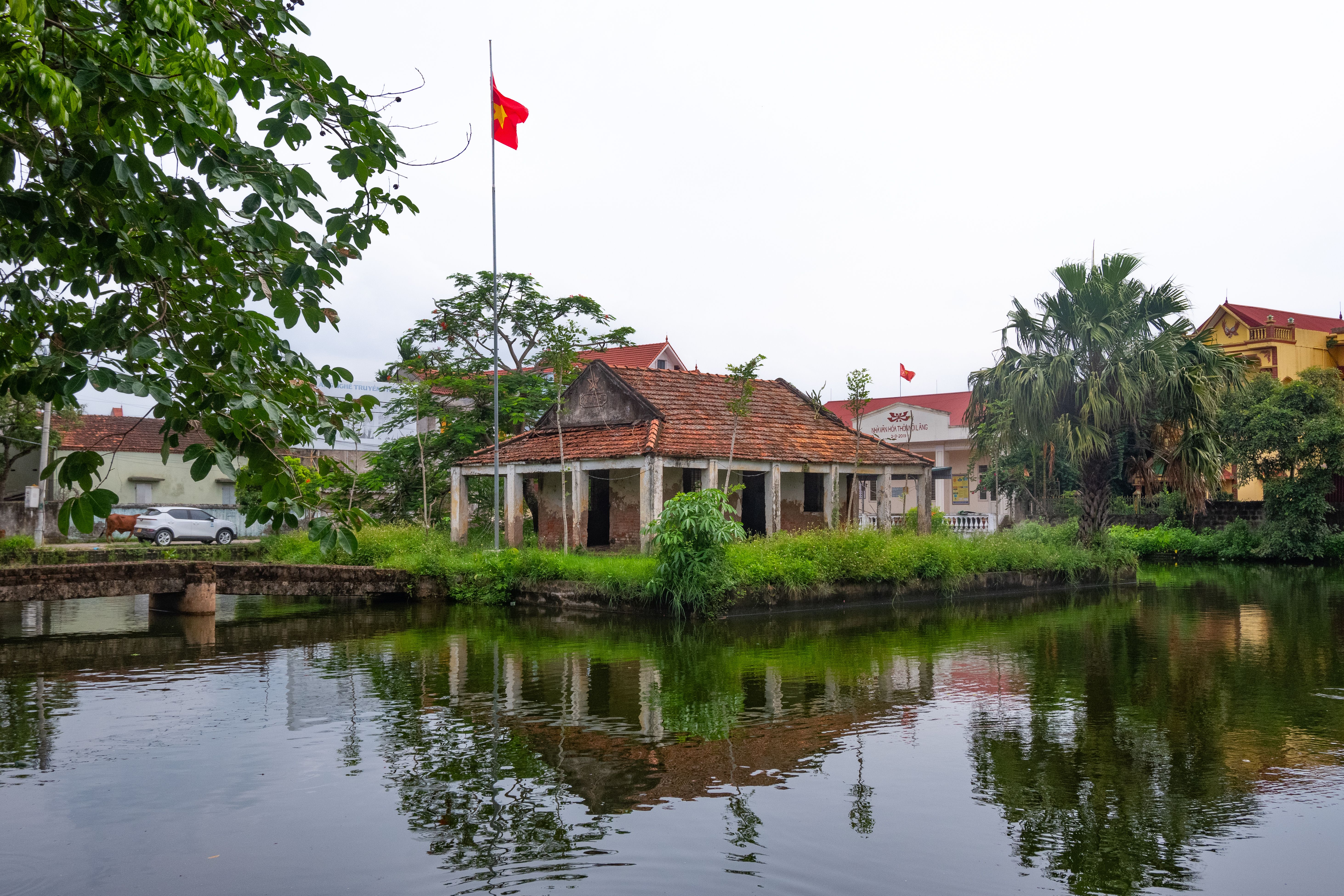 Tranquil village scene featuring traditional Vietnamese architecture by the water in Hưng Yên, Vietnam.