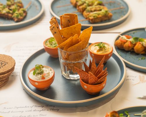 Free A stylish assortment of crackers, dips, and appetizers on a blue platter. Stock Photo