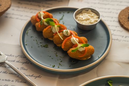 Free Close-up of gourmet croquettes with garnish and sauce, perfect for culinary themes. Stock Photo
