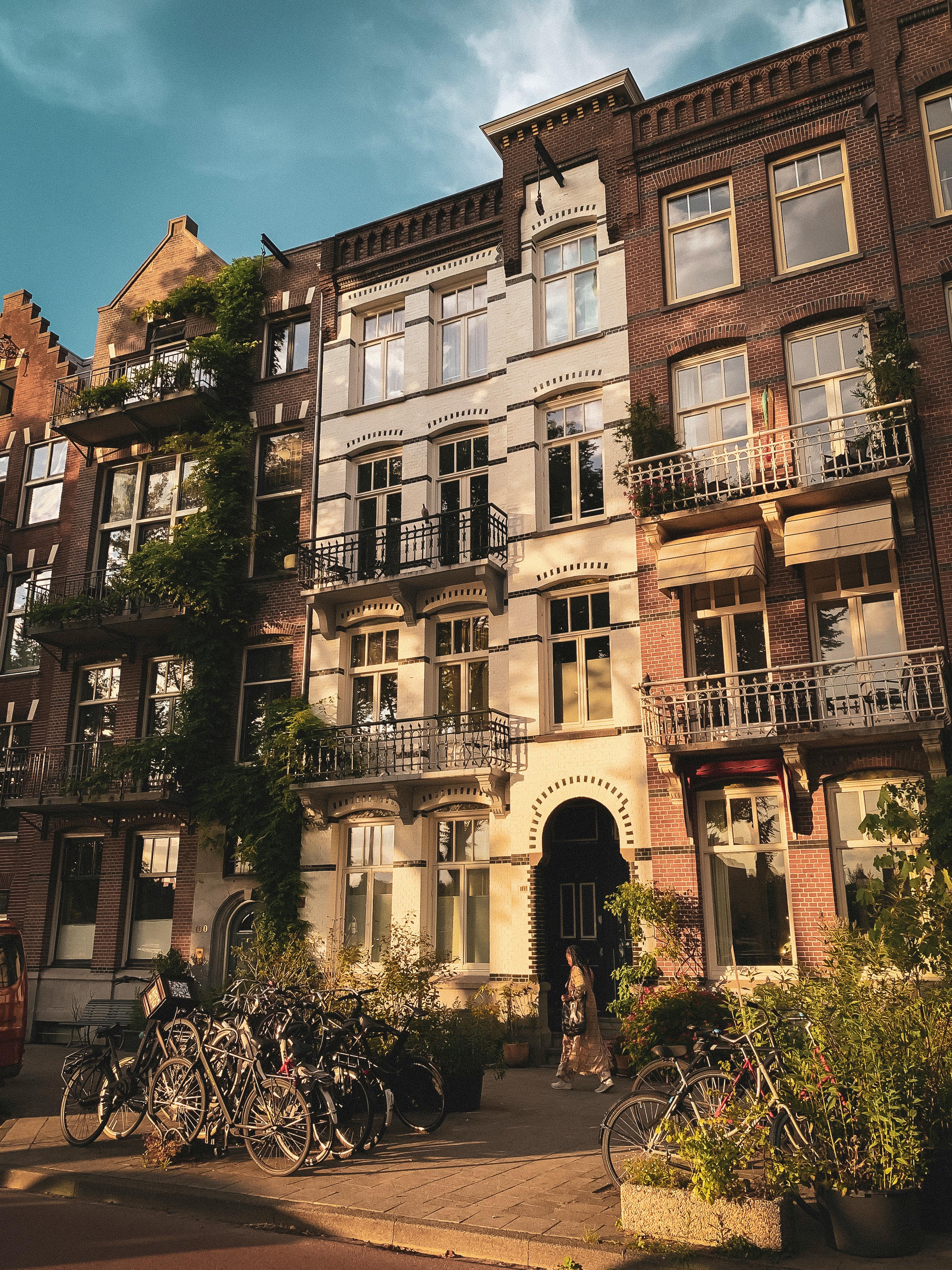 Charming Dutch facade with bicycles in Amsterdam during sunset.