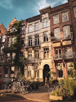 Charming Dutch facade with bicycles in Amsterdam during sunset.