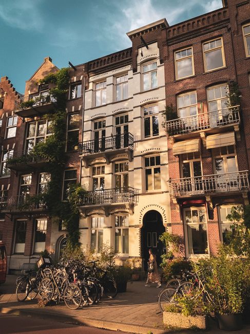 Charming Dutch facade with bicycles in Amsterdam during sunset.