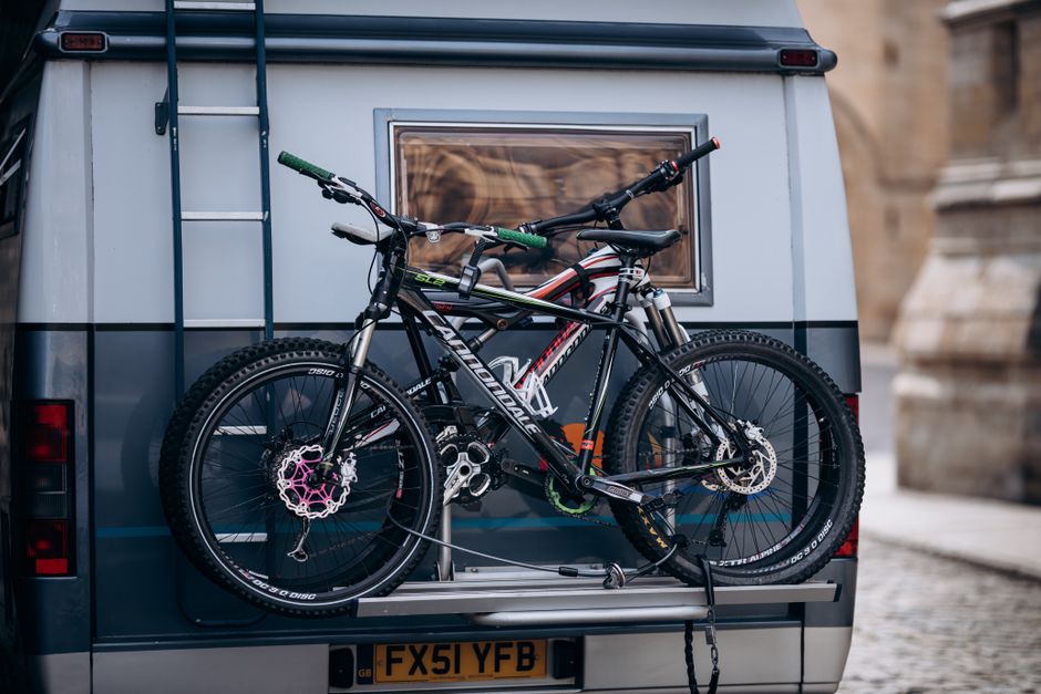 Two mountain bikes secured on a camper for travel or outdoor exploration. Perfect setup for biking trips.