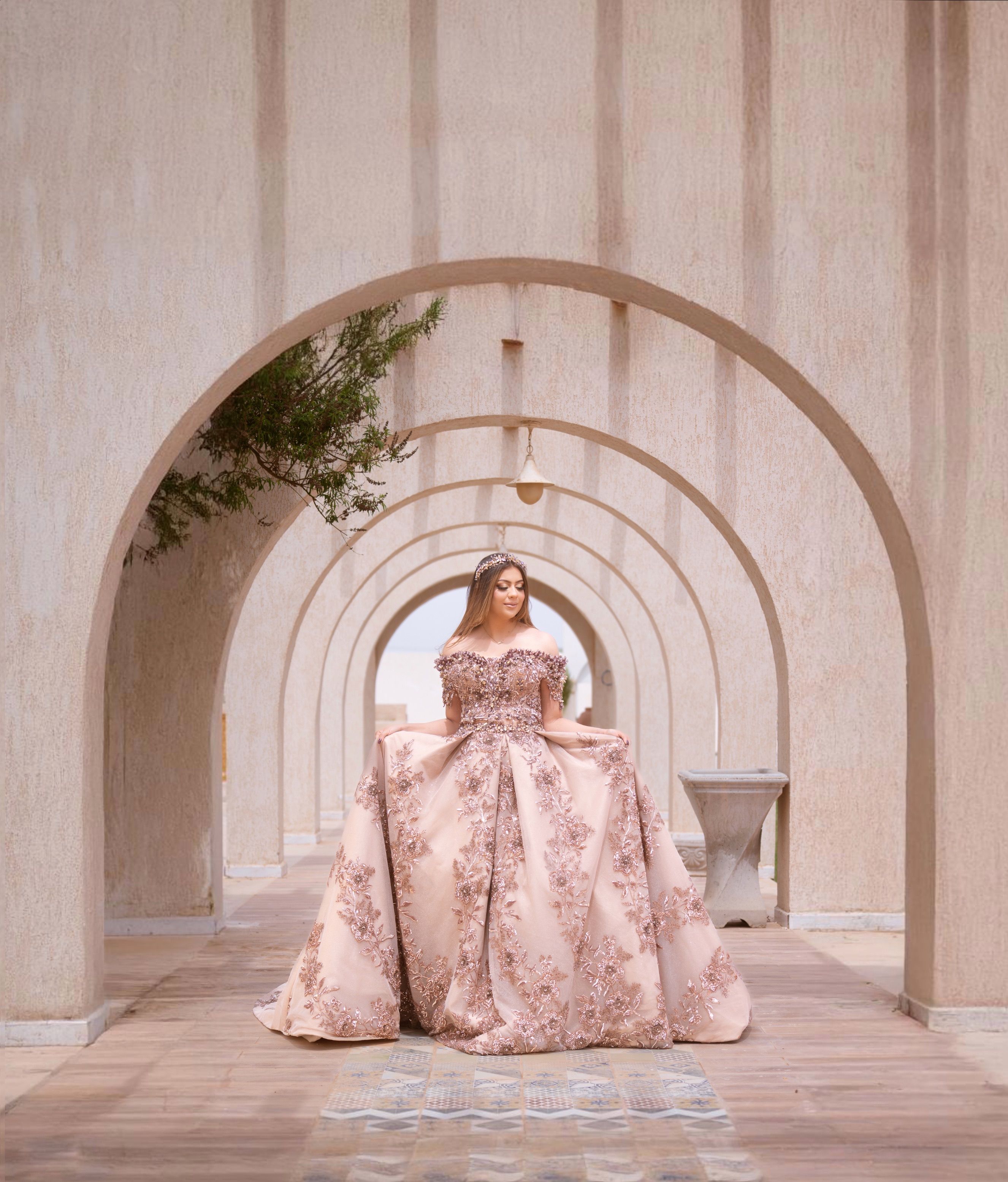 Elegant Bride in Ornate Dress at Tunisian Arches