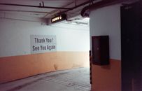 An underground car park exit in Singapore with 'Thank You! See You Again' signage.