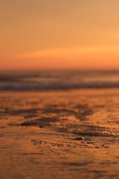 Captivating sunset view over Lacanau beach with gentle waves and warm hues.