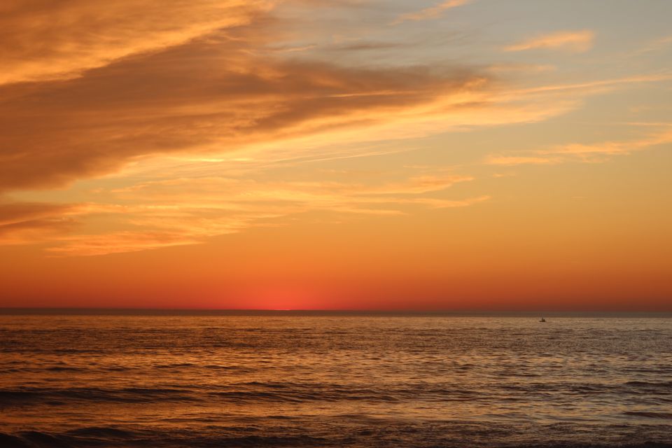 Beautiful sunset view over Lacanau beach with vibrant orange and pink skies.
