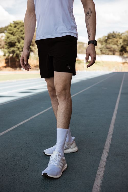 Free Male athlete wearing sportswear and sneakers standing on a running track. Stock Photo