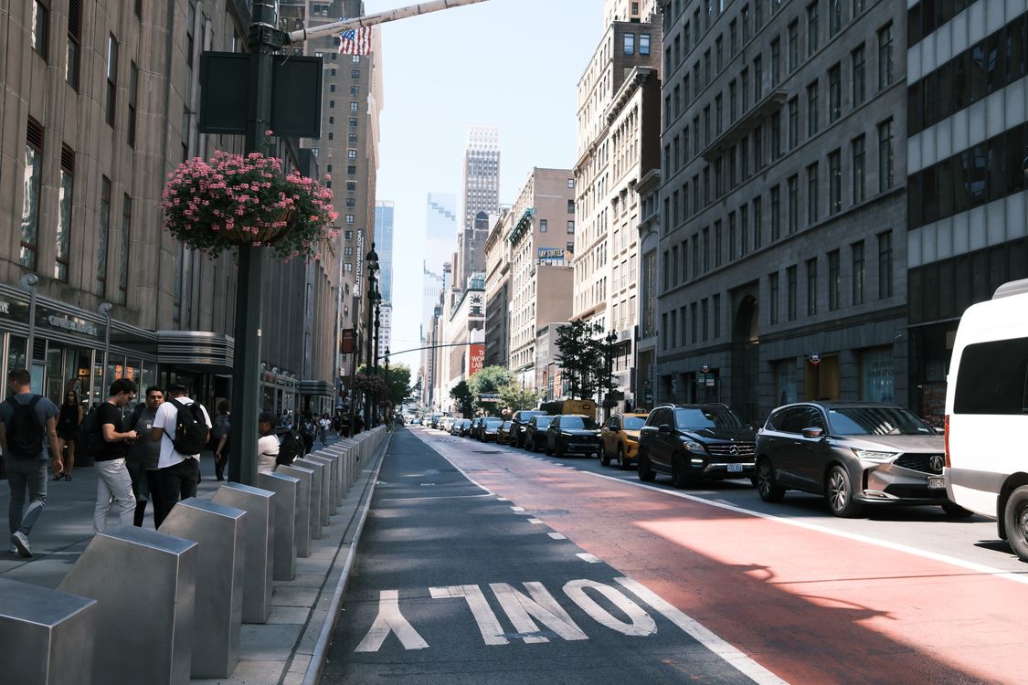 Contemporary New York street with pedestrians, city traffic and architectural depth