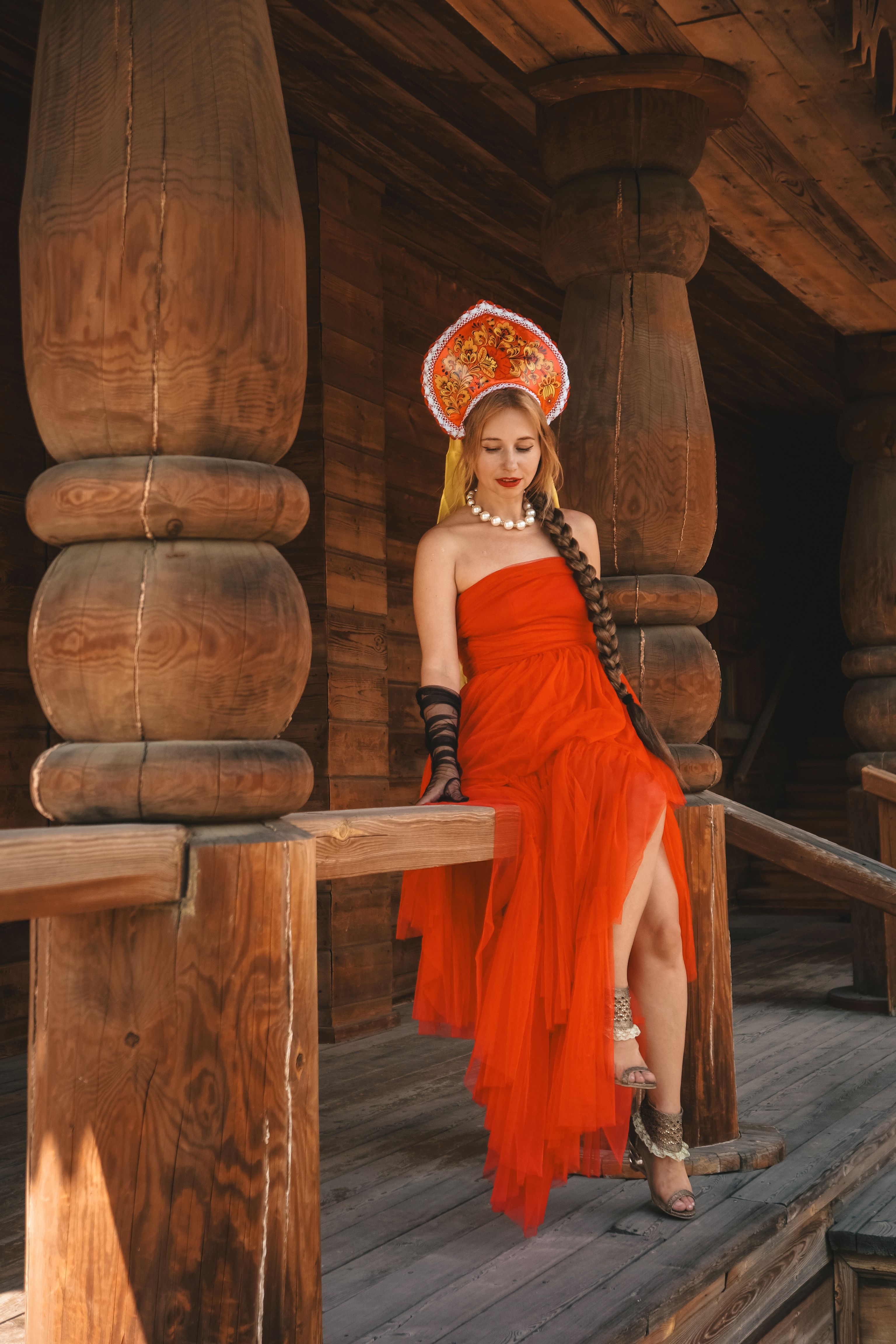Elegant Woman in Red Dress in Rustic Setting · Free Stock Photo