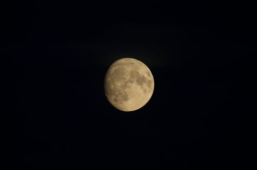 A striking image of the full moon illuminating the dark night sky, showcasing lunar details.