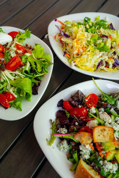Free Discover a vibrant array of fresh gourmet salads at a Denver outdoor dining spot. Stock Photo