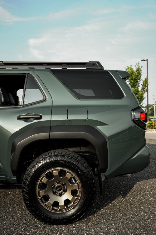 Free Green SUV featuring off-road tires and sleek design parked outdoors Stock Photo
